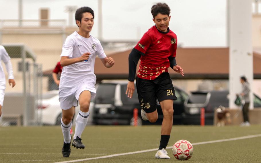 Michael Domndon and Juvenal Jiminez follow the ball.