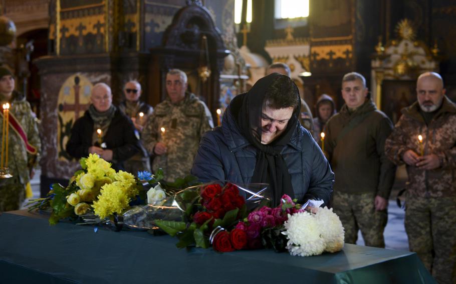 Mziia Dvali, a Georgian native living in Kyiv, Ukraine, weeps at the casket of Gurgen Gagnidze at a funeral at St. Volodymyr's Cathedral on Nov. 1, 2022. Dvali, 66, said she felt immense grief thinking about the death of Gagnidze, a 40-year-old soldier in the Georgian Legion who died in late October while fighting Russian troops. 