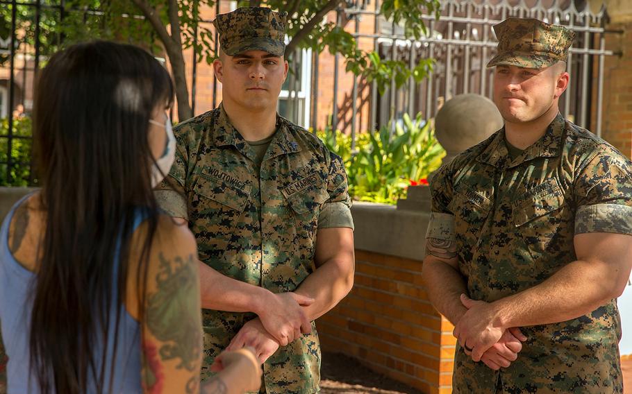 Virginia Waller-Torres talks to Cpl. Mitchell Wojtowicz, left, and Cpl. Jared Tosner after she met them at Marine Barracks Washington, Sept. 20, 2021. Waller-Torres thanked them for helping push her car out of floodwaters near Arlington Cemetery during a downpour on Sept. 16.