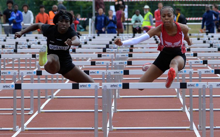Hohenfels’ Kenya Tucker and Kaiserslautern’s Lellah Guhn are even going over the last hurdle in the girls 100-meter hurdles event at the 2025 DODEA-Europe track and field finals, in Kaiserslautern, Germany, but Guhn went on to win the race in 15.48 seconds ahead of Tucker’s15.52.