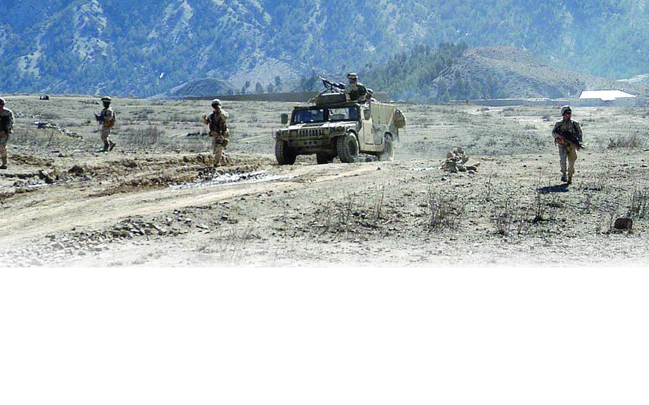 Soldiers from 1st Platoon, Company A, 1st Battalion, 508th Infantry Regiment patrol along a road in eastern Afghanistan. They were on a two-day mission to the villages of Zarwuk and Naka.