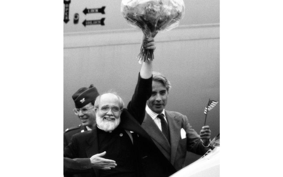 Wiesbaden, Germany, July 28, 1986: Rev. Lawrence M. Jenco waves to a crowd of well-wishers from a balcony at the Air Force Regional Medical Center in Wiesbaden. The Catholic priest was on his way home to Illinois after being released by Islamic Jihad, which had held him captive in Lebanon for 19 months.