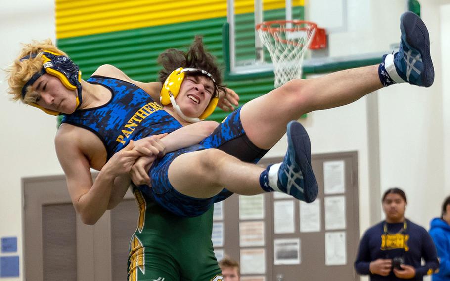 Robert D. Edgren's Nikolas Hawkins lifts Yokota's Aiden Greer airborne at 141 pounds during Saturday's DODEA-Japan wrestling tri-meet. Hawkins won by technical fall and the Eagles won the meet 23-14.
