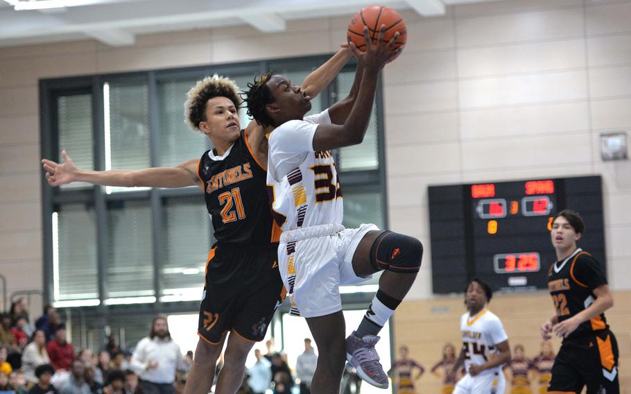 Baumholder’s Gregory Makubaya gets past Spangdahlem’s  Cameron Lewis on his way to the basket in the Division III championship game at the DODEA-Europe basketball finals in Ramstein, Germany, Feb. 18, 2023. Baumholder took the title with a 40-27 win. 