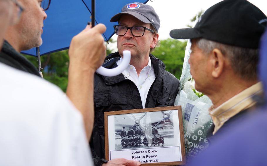 Bill O’Connor, nephew of U.S. Army Air Forces 2nd Lt. Edward O'Connor, holds a photo of a U.S. B-29 Superfortress crew while visiting Tokyo Bay on June 9, 2023. His uncle died when the bomber went down in the bay on March 10, 1945.