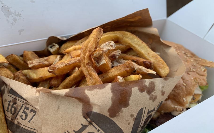 A heaping helping of fries at Burger 16/57 in Kaiserslautern dwarfs the juicy bacon-and-egg burger in a takeout order June 1, 2021.