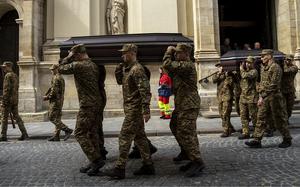 Soldiers carry the coffins of two Ukrainian army sergeants during their funeral in Lviv, Ukraine, on April 16, 2024. 