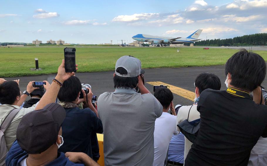 Friendship Festival patrons snap photos of Air Force One as it lands at Yokota Air Base, Japan, Sunday, May 22, 2022. 