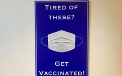 A poster in the Pentagon on Thursday encourages personnel to get their coronavirus vaccine to remove their masks in Defense Department facilities. (Caitlin Doornbos/Stars and Stripes)