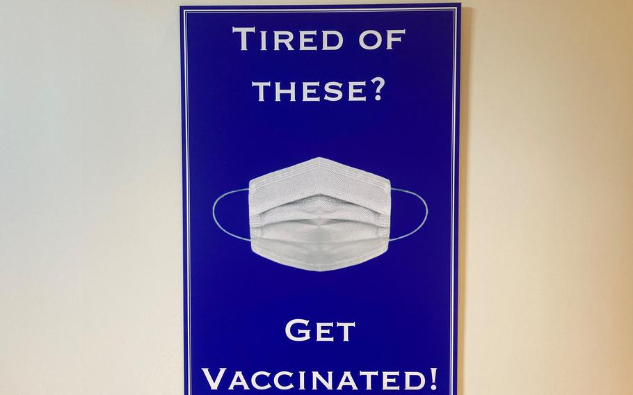 A poster in the Pentagon encourages personnel to get their coronavirus vaccine to remove their masks in Defense Department facilities.