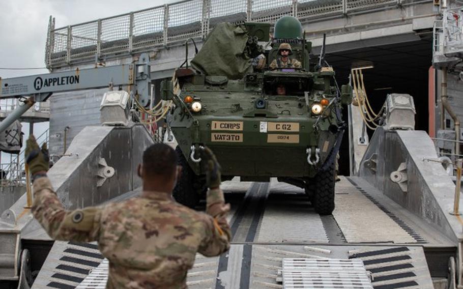 U.S. Army soldiers with I Corps unload a Stryker combat vehicle off the USNS City of Bismarck during a training operation at Naval Base Guam on Feb. 9, 2022. 