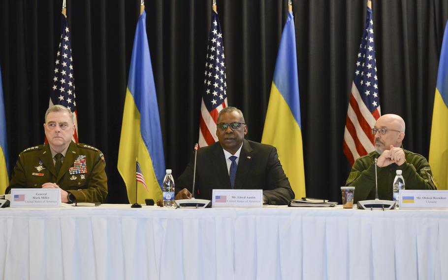 From left, U.S. Army Gen. Mark Milley, U.S. Defense Secretary Lloyd Austin and Oleksii Reznikov of Ukraine give opening remarks on military cooperation during the Ukraine Defense Contact Group meeting April 21, 2023, at Ramstein Air Base in Germany.