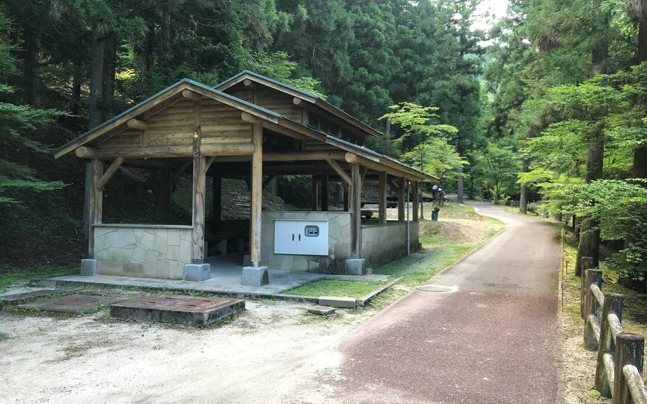 A pavilion for cooking and gathering stands near the platform camping sites at Jakuchikyo Camping Ground, Yamaguchi prefecture, Japan.