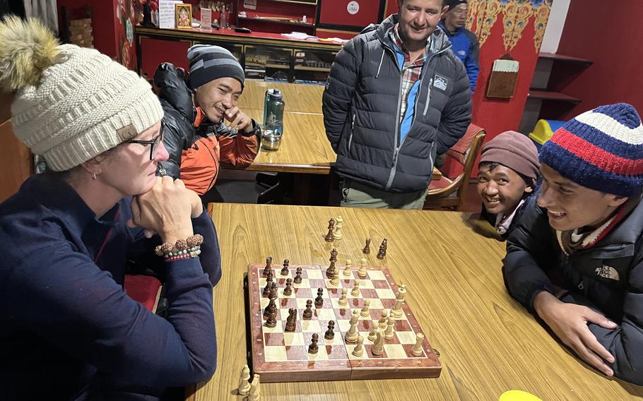 Marga Kellogg Cooley plays a game of chess with one of the porters. She lost. 