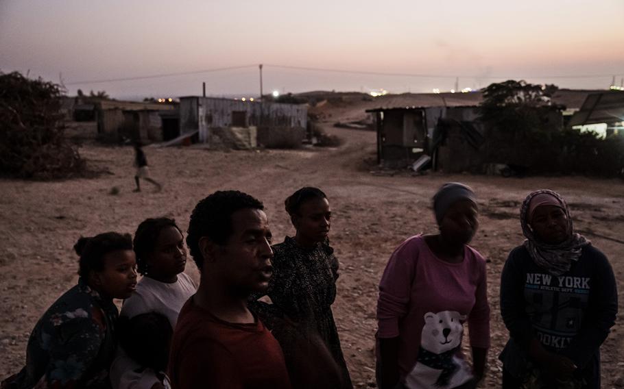 People stand in Wadi al Naam, the largest unrecognized Bedouin village in Israel with as many as 15,000 residents.