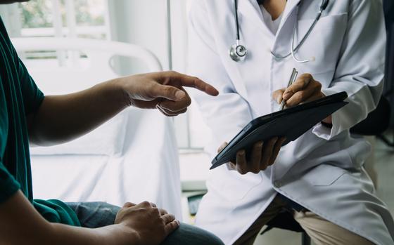close up of patient and doctor taking notes