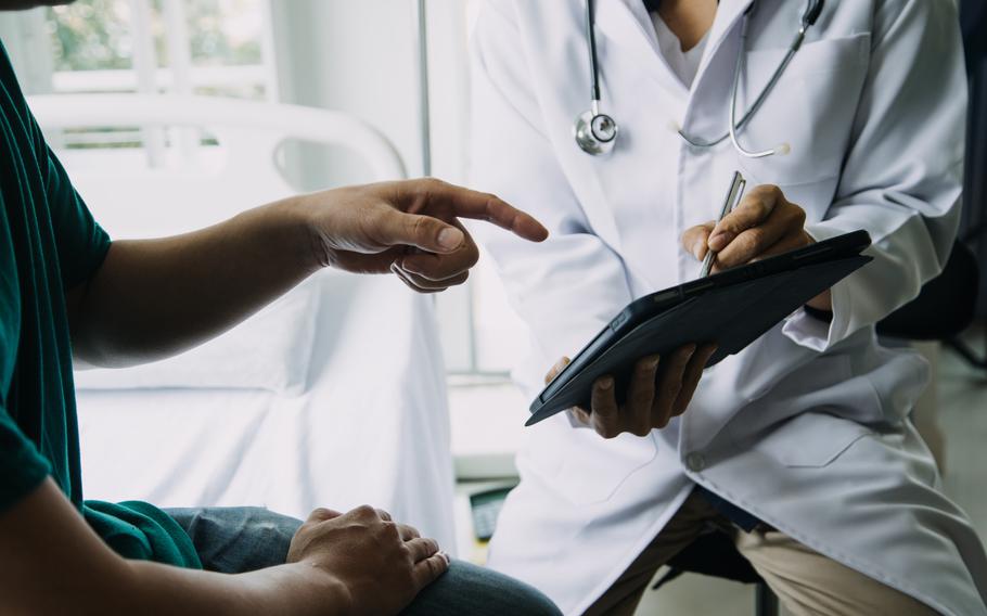 close up of patient and doctor taking notes