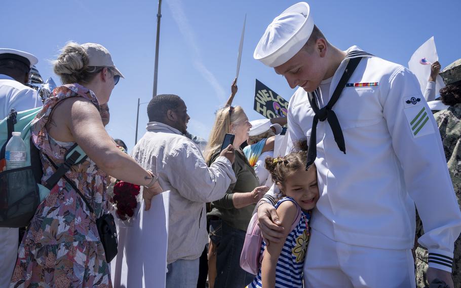 Airman Robert Valdez, assigned to the USS George H.W. Bush, embraces a family member after the ship’s return to Naval Station Norfolk, Sunday, April 23, 2023. 