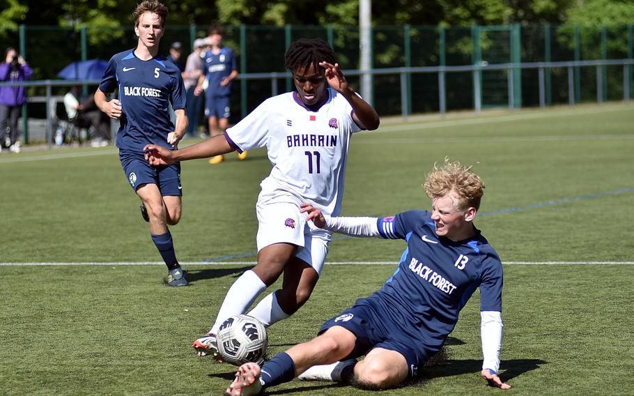 Black Forest Academy defender Jack Cox tackles Bahrain midfielder Nkanyiso Gumede during the first day of pool-play action at the 2025 Division II DODEA European championships at the stadium of VfB Reichenbach on May 19, 2025, in Reichenbach-Steegen, Germany.