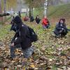 Polish civilians kneel as they listen to a soldier at the Military University of Technology in Warsaw, Poland, explain how to survey their surroundings while marching through dangerous areas, as part of a familiarization course Nov. 5, 2022.
