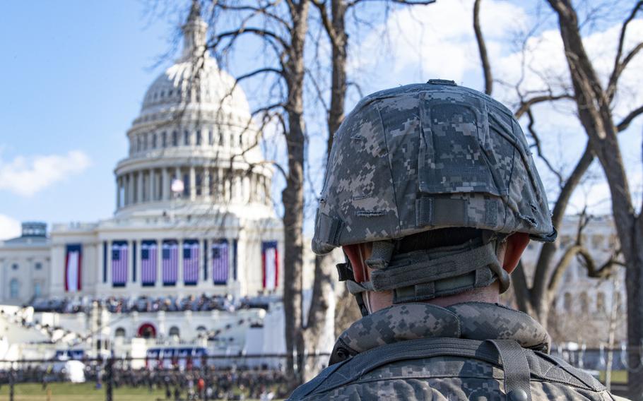 A member of the 2nd Squadron, 107th Cavalry Regiment of the Ohio National Guard watches the 59th Presidential Inauguration near the U.S. Capitol building in Washington, D.C., on Jan. 20, 2021. 