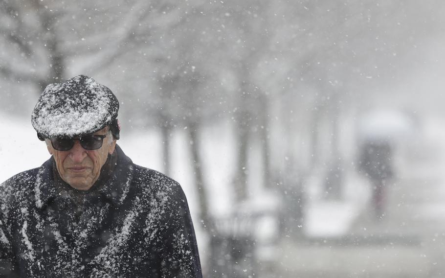 A man makes his way through snowfall in Sarajevo, Bosnia, Tuesday Jan. 22, 2019. Heavy snow descended on the Balkan countries causing havoc throughout the region. 