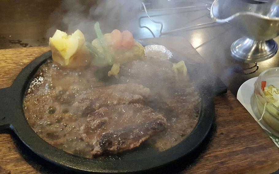 The hamburger-and-lamb set from Sherlock Holmes, a hamburger and steak restaurant near Yokota Air Base in western Tokyo, is served with vegetables and a baked potato.