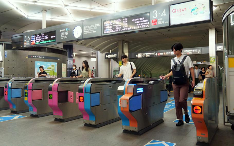 Commuters enter the Denentoshi Line at Shibuya Station in Tokyo, Wednesday, Aug. 23, 2023. 