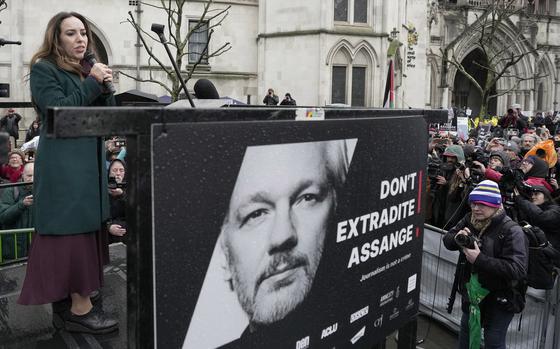 Stella Assange speaks besides a poster of husband Julian Assange at the Royal Courts of Justice in London on Feb. 21, 2024.
