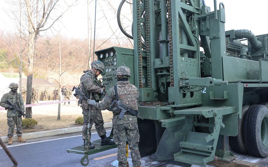 South Korean soldiers simulate a rescue of people trapped underground using a drilling rig in Seoul, South Korea, on Dec. 27, 2023. 