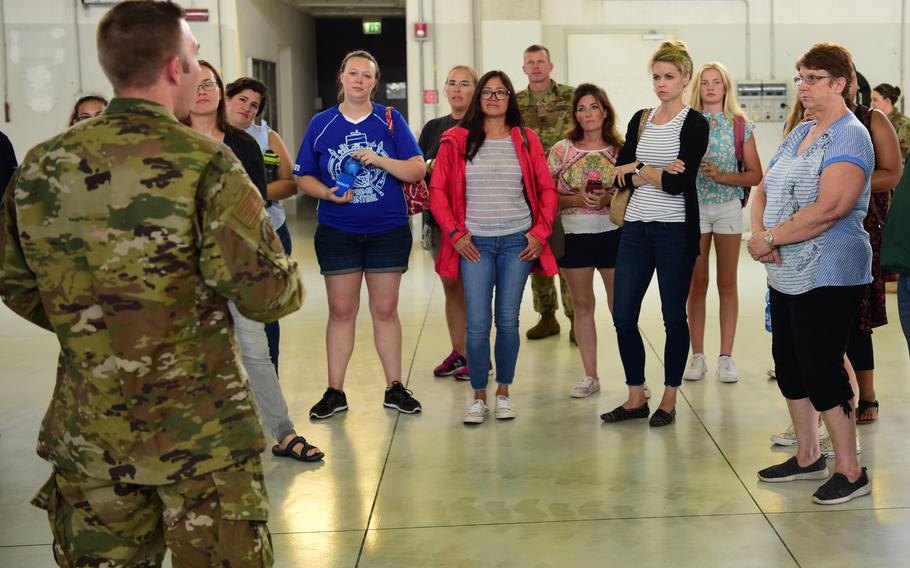 Spouses and family members listen to a brief during a spouse day on August 2, 2019, at Aviano Air Base, Italy. Military spouses in Italy have encountered limited employment opportunities when accompanying their service member to Italy.