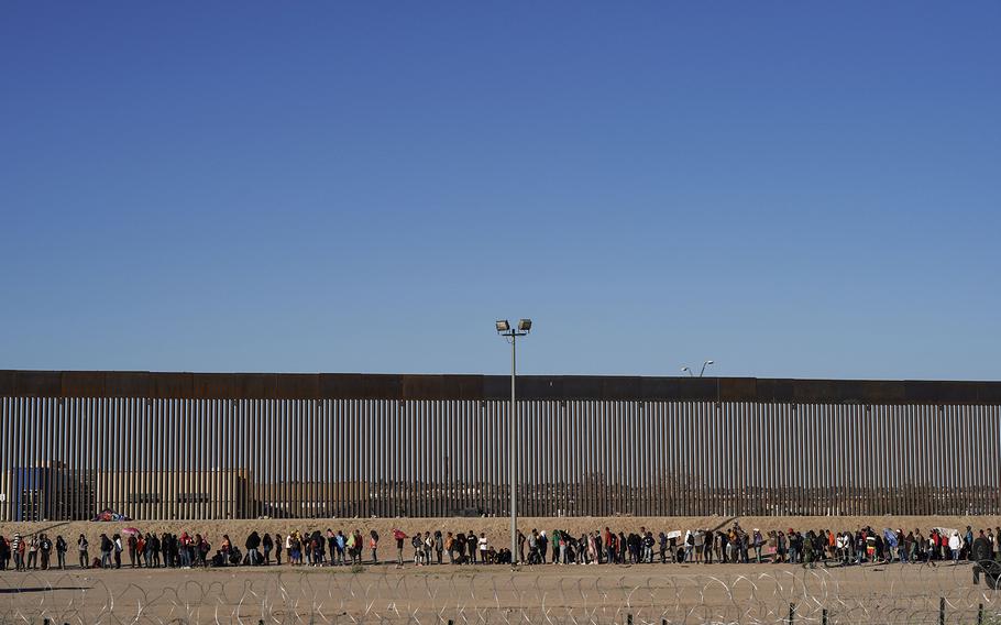Migrants line up to be processed by U.S. Border Patrol agents Tuesday, Sept. 19, 2023, along the border at Ciudad Juárez, Mexico. 