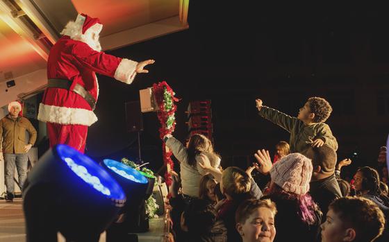 Children wave to Santa Claus on stage during the tree lighting at Marine Corps Air Station Iwakuni, Japan, on Dec. 3, 2022.