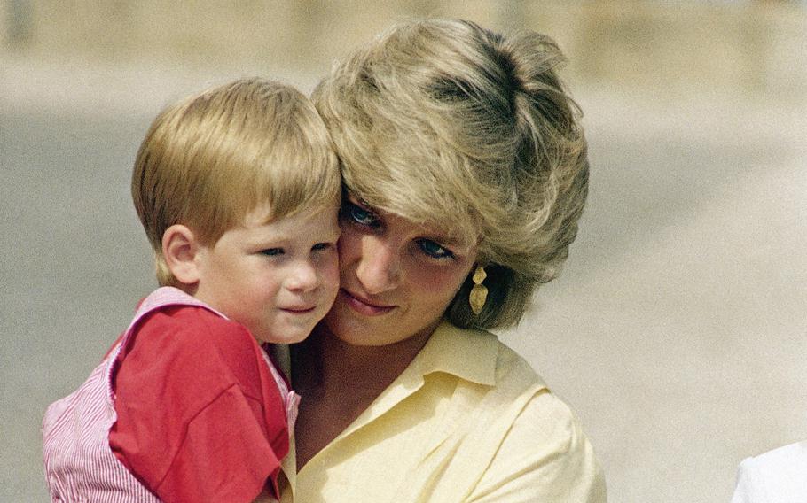 Diana, the Princess of Wales holds son Prince Harry while royal families posed for photographers at the Royal Palace, in Majorca, Spain, on Aug. 9, 1987. An explosive memoir reveals many facets of Prince Harry, from bereaved boy and troubled teen to wartime soldier and unhappy royal. From accounts of cocaine use and losing his virginity to raw family rifts, “Spare” exposes deeply personal details about Harry and the wider royal family. It is dominated by Harry’s rivalry with brother Prince William and the death of the boys’ mother, Princess Diana in 1997. 