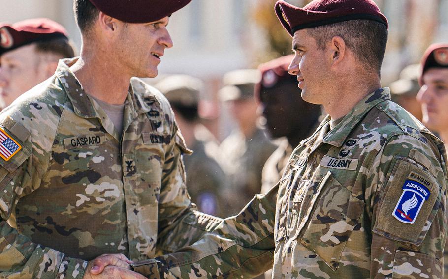 Col. Joshua Gaspard, the 173rd Airborne Brigade commander, left, welcomes new paratroopers during a patching ceremony July 26, 2023, at Caserma Del Din in Vicenza, Italy.