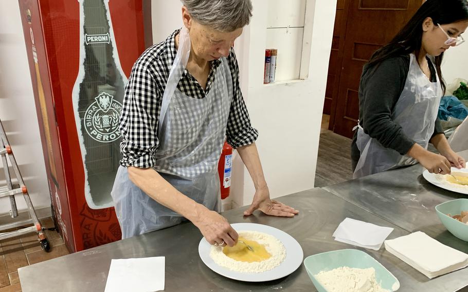 A woman makes pasta
