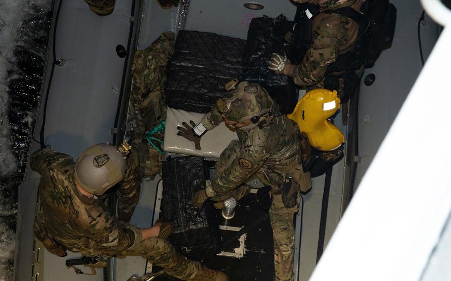 Service members prepare to offload contraband.