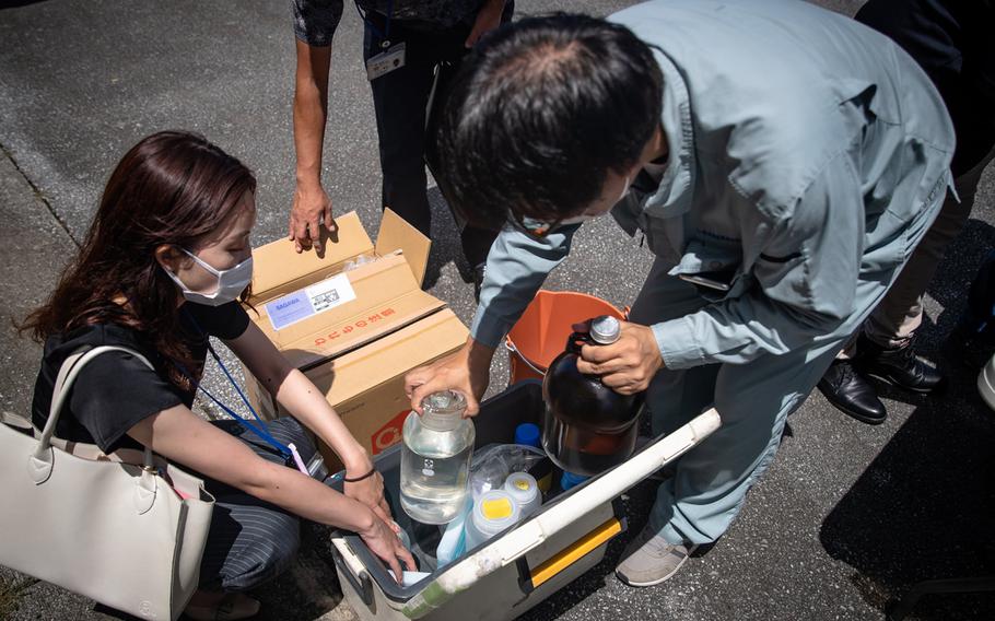 Japanese officials collected samples of treated wastewater at Marine Corps Air Station Futenma, Okinawa, Monday, July 19, 2021.