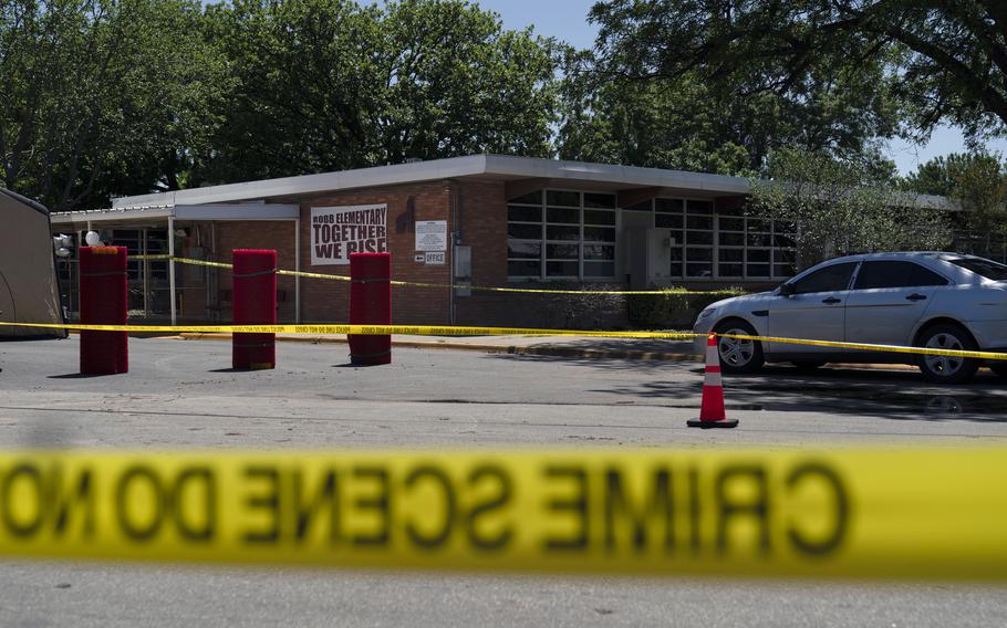 Crime scene tape surrounds Robb Elementary School in Uvalde, Texas, Wednesday, May 25, 2022.
