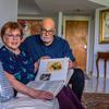 Evelyn Walg Grunberg and her son Henry Grunberg look through a family album in her apartment in Aventura. The family will gather in France this summer to commemorate Evelyns escape from Nazi Europe in 1942.