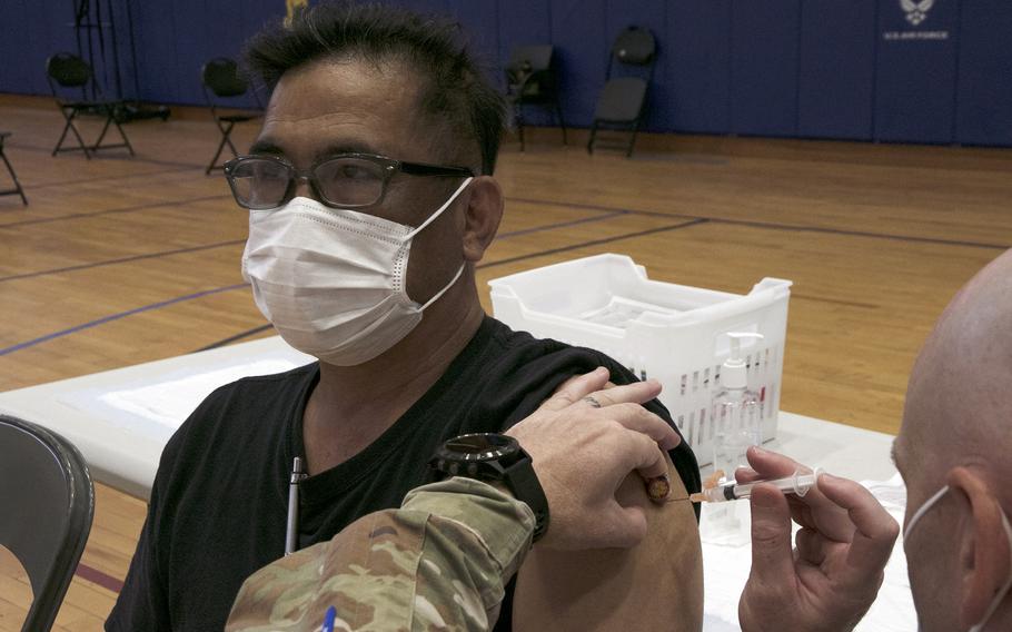 Firefighter Tadashi Seikima, 53, receives his first dose of the Moderna COVID-19 vaccine at Kadena Air Base, Okinawa, Wednesday, June 16, 2021.