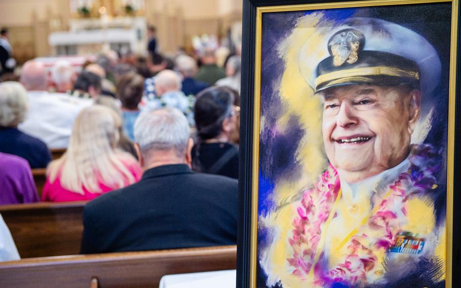 An oil painting of retired Lt. Cmdr. Louis (Lou) Conter, painted by Julie Thurston of Julie Thurston Fine Art, is displayed during his memorial service at the St. Patrick Catholic Church, Grass Valley, Calif, Tuesday, April 23, 2024. Conter was 102 when he passed away peacefully in his home. In addition to being the last living USS Arizona survivor, Conter also flew more than 200 missions in the South Pacific and survived being shot down twice.