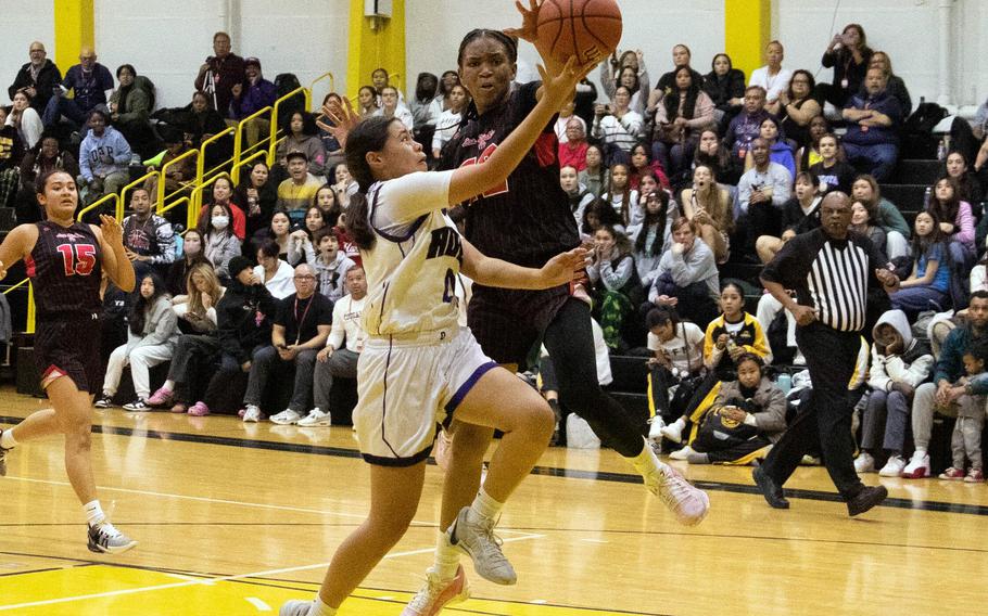 Academy of Our Lady's Audrey Shinohara has her shot blocked by Nile C. Kinnick's KaMiyah Dabner. The Cougars won the ASIJ Kanto Classic girls final 27-19.