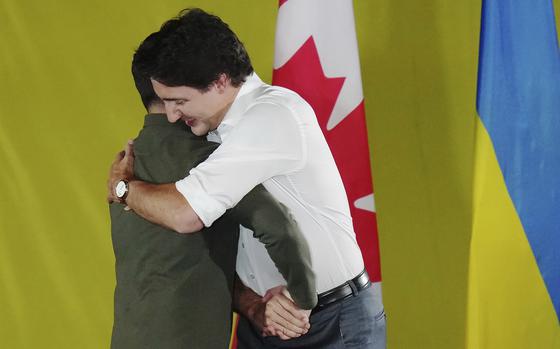 Prime Minister Justin Trudeau, right, embraces Ukrainian President Volodymyr Zelenskyy as he is introduced during a rally at the Fort York Armoury in Toronto on Friday, Sept. 22, 2023. (Chris Young/The Canadian Press via AP)