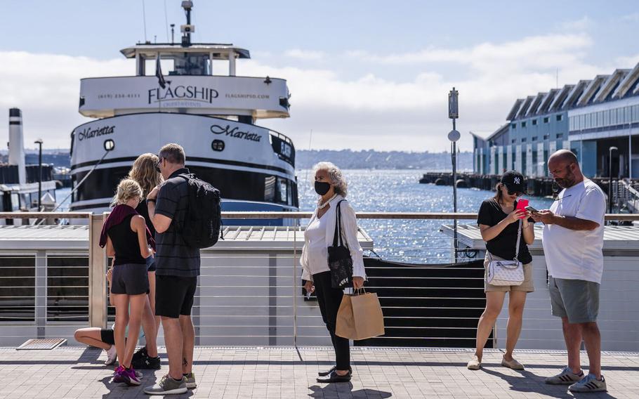 Merrilee Kazarian wears a face mask while waiting for the ferry in downtown San Diego on July 7, 2022. Kazarian says there has been an uptick in cases and she’s had 4 shots for Covid-19 “I don’t want a mild case and I’m a healthy person.”