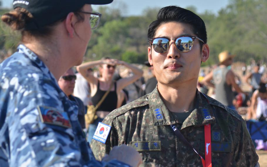 Australian and South Korean airmen chat during an aerobatics display that included flyovers by fighter jets from both countries in Darwin, Australia, Thursday, Aug. 25, 2022. 