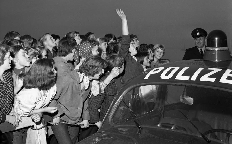 Hundreds of screaming teenage Presley fans greeted their khaki-clad hero who, with duffel bag on his shoulder, walked off the gangway. 