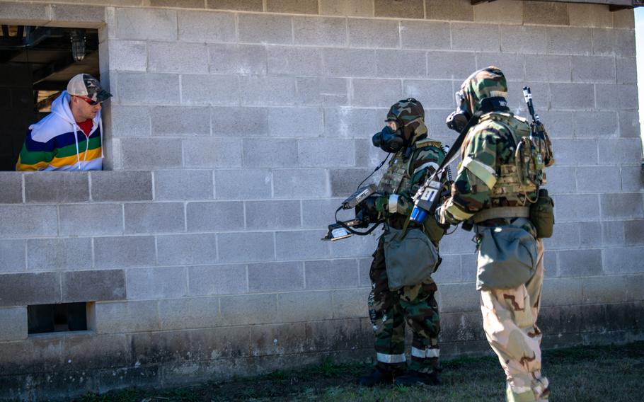 Airmen participating in PATRIOT 24 survey an area for radiological hazards and notify a role-play homeowner on proper precautions to take during PATRIOT 24, Camp Shelby, Miss., Monday, Feb. 19, 2024.