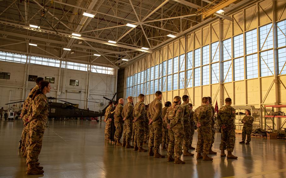 A group of U.S. Army Georgia National Guard Soldiers, assigned to Detachment One, Charlie Company,  1st Battalion, 111th Aviation Regiment, stands at parade rest during morning formation at Hanger One, Dobbins Air Force Reserve Base, Marietta, Ga., Jan. 8, 2022.