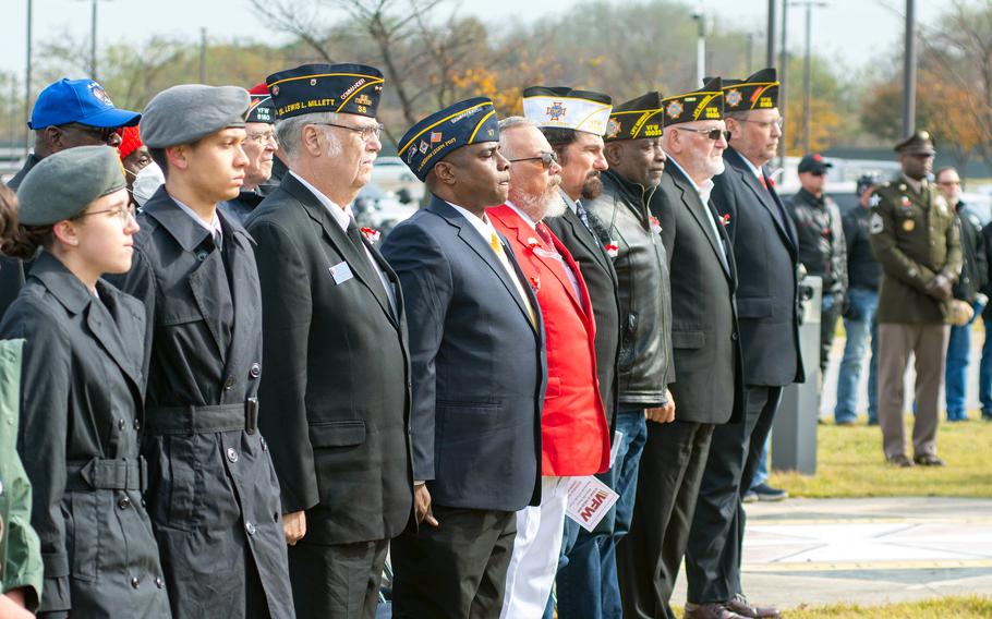 Veterans, active-duty service members and others celebrate Veterans Day with a ceremony at an Army memorial on Camp Humphreys, South Korea, Nov. 11, 2023.